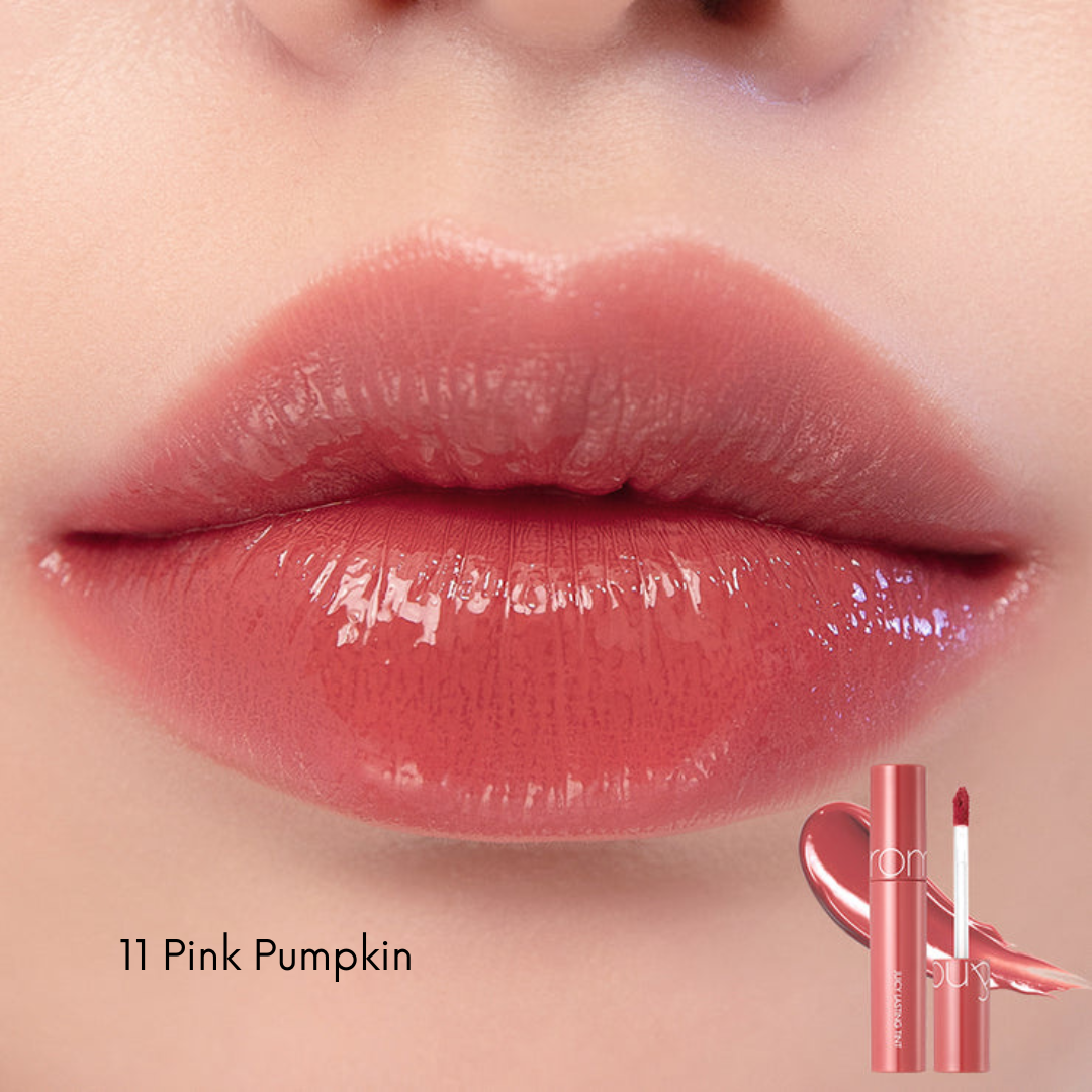 Rom&nd Juicy Lasting Tint lip tint in a vibrant shade, showing the product tube and applicator on a neutral background.
