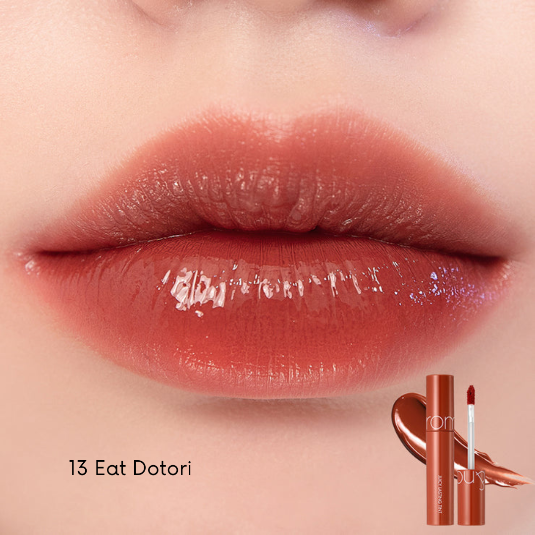 Rom&nd Juicy Lasting Tint lip tint applicator with vibrant pink color on lips and a close-up of the product tube.