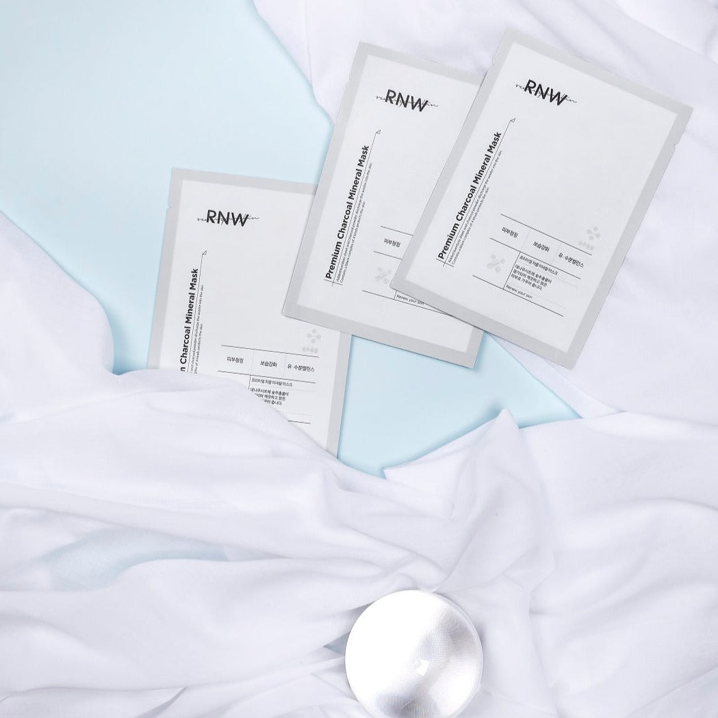 RNW Premium Charcoal Mineral Sheet Mask on a white background, showcasing the black mask sheet with mineral ingredients.