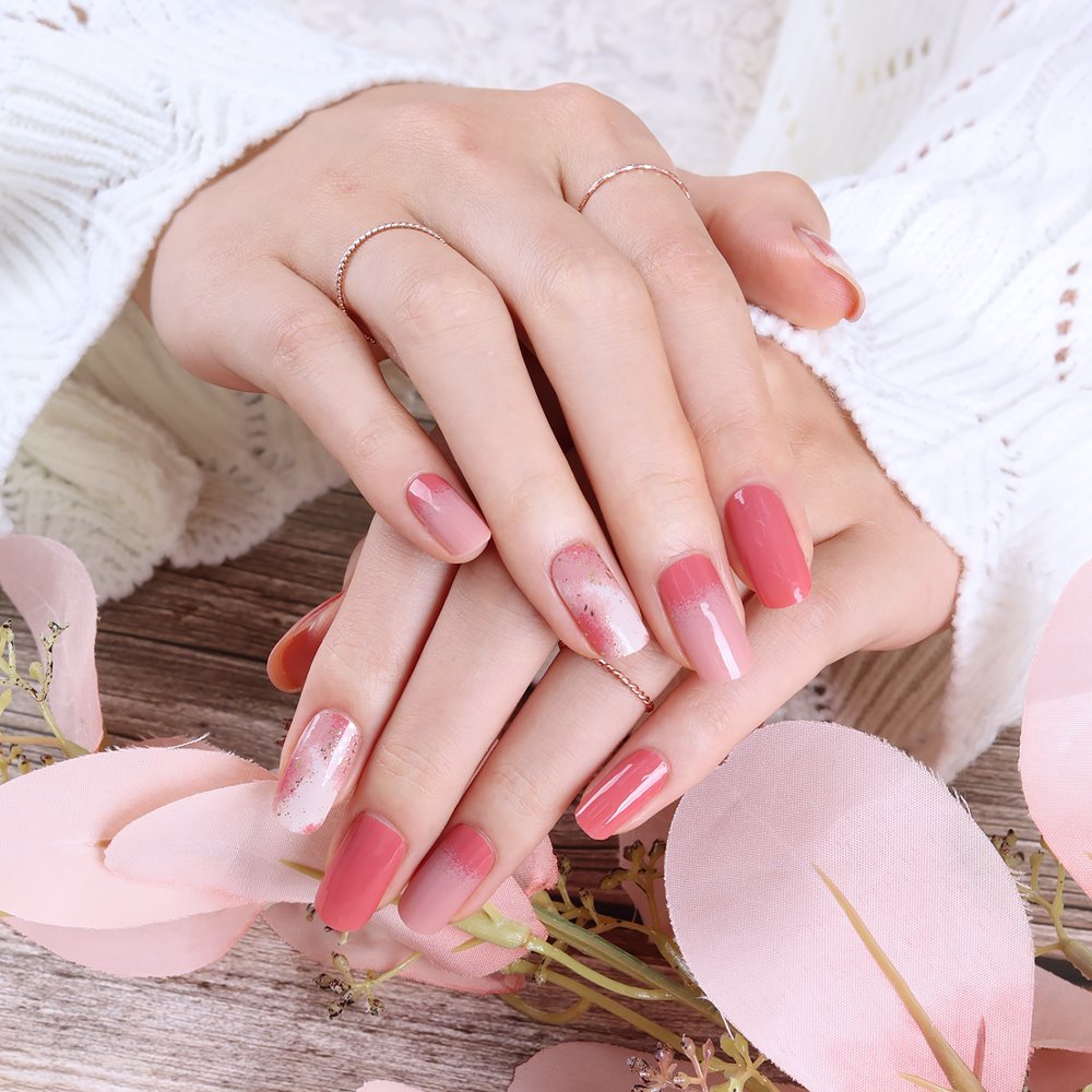 Glossy Blossom Gel Nail Strips in Rose Blusher with pink and nude floral designs on neatly manicured nails.