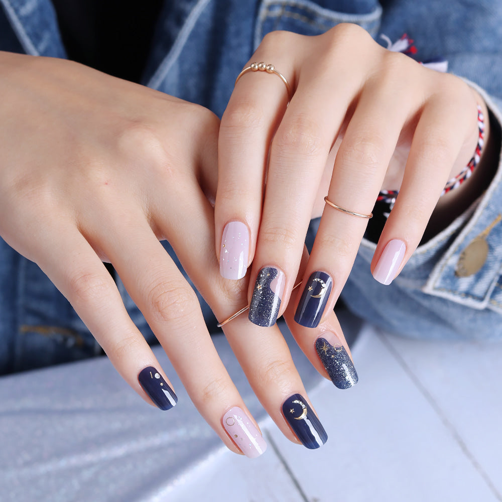 Glossy Blossom gel nail strips in Midnight Sky with a dark, starry sky design for easy at-home manicures.