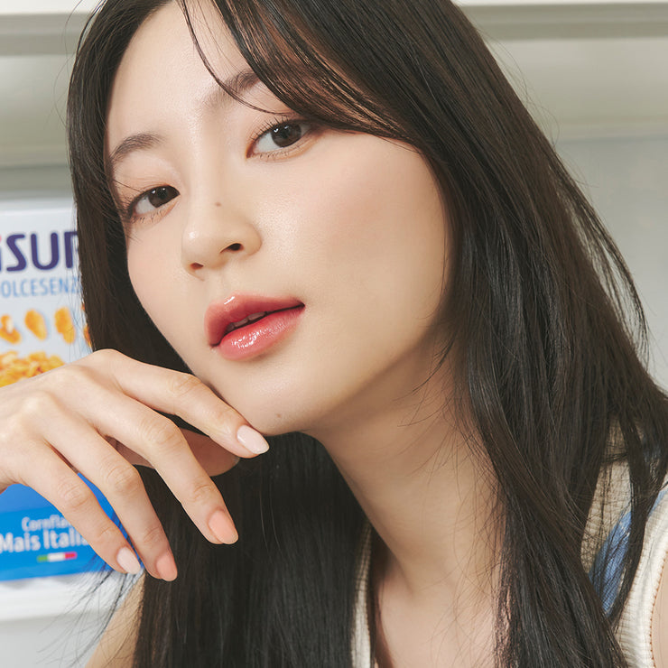Rom&nd Juicy Lasting Tint lip tint tube with applicator showing vibrant color on the product.