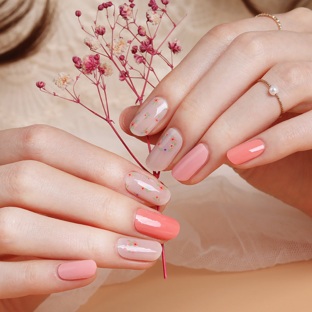 Glossy Blossom floral blusher gel nail strips on nails with pink and white floral pattern for a stylish manicure.