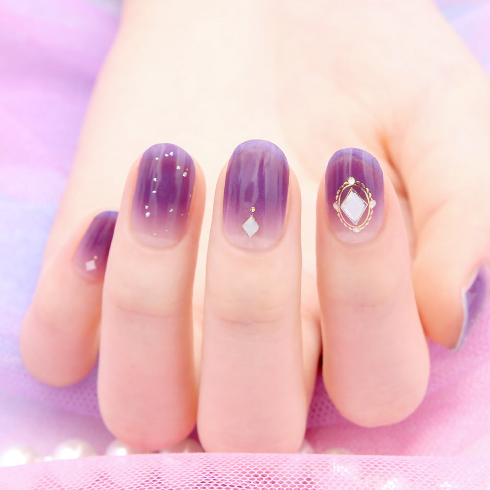 Glossy Blossom gel nail strips featuring intricate Serenade of Fascination design for stylish, easy-to-apply nail art.