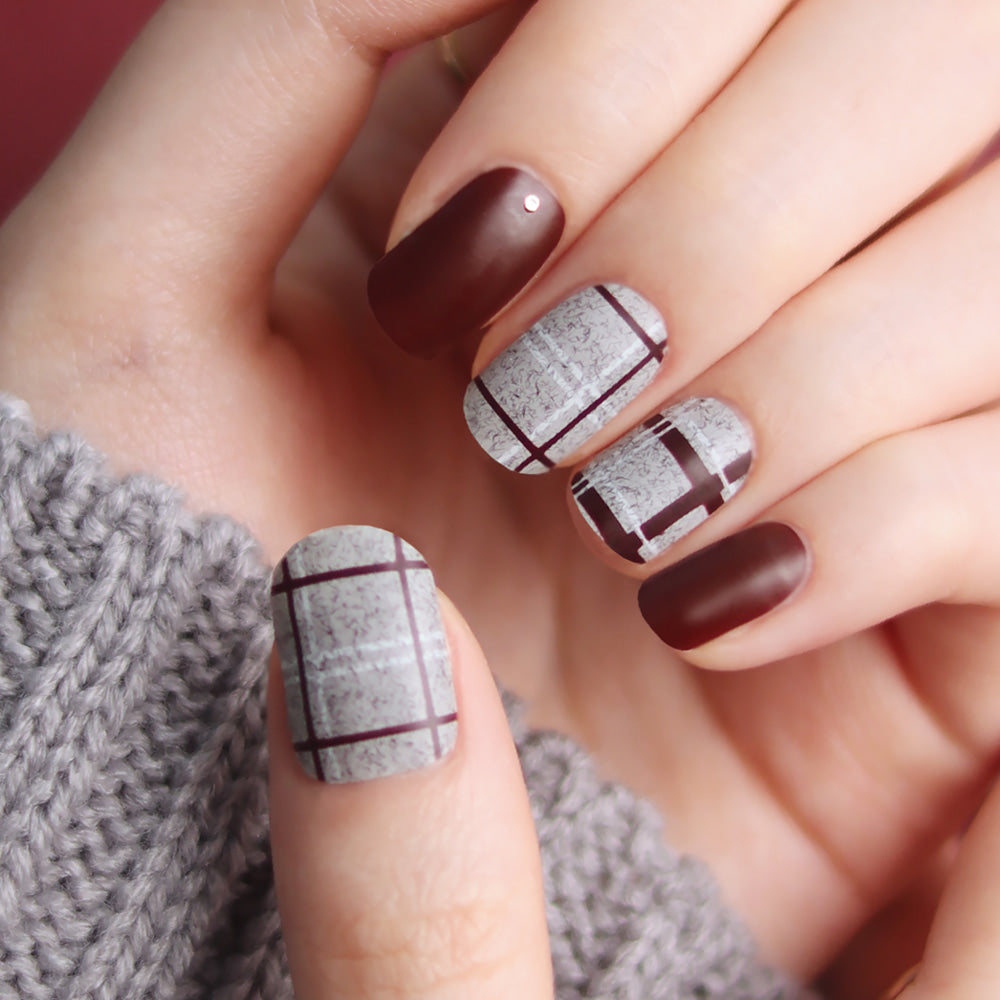Glossy Blossom burgundy velvet check matte gel nail strips displayed on neatly arranged nails with a checkered design.