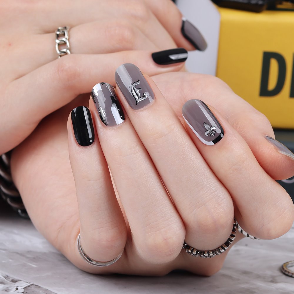 Glossy Blossom Hip Black gel nail strips on nails, showcasing sleek black design with glossy finish for stylish manicures.
