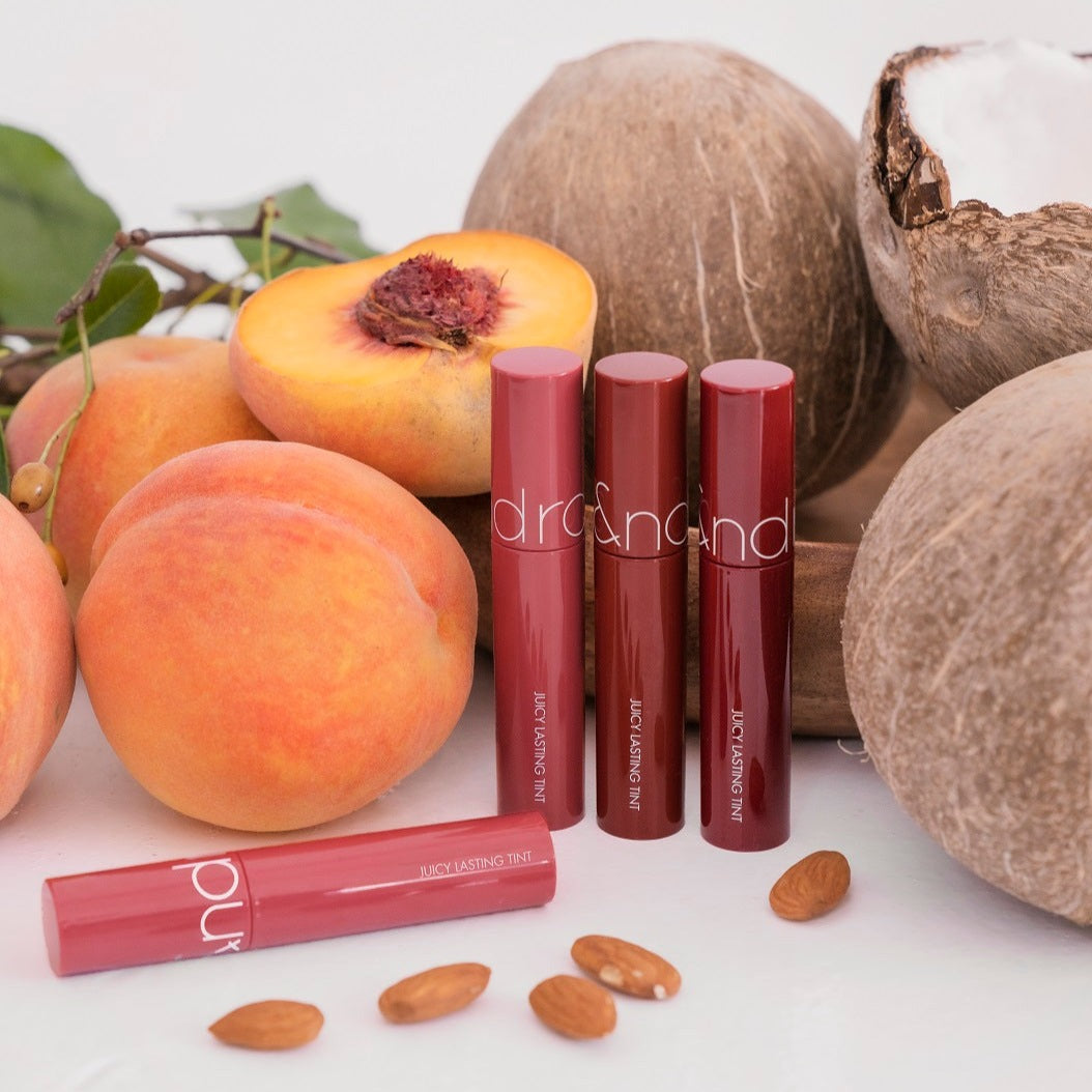 Rom&nd Juicy Lasting Tint lip tint in a sleek tube, with the applicator visible, showcasing vibrant color and smooth texture.