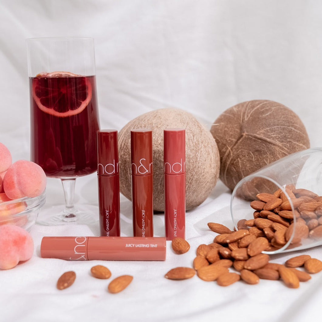 Rom&nd Juicy Lasting Tint lip tint in a vibrant shade, showcased in a close-up image highlighting glossy, colorful lips.