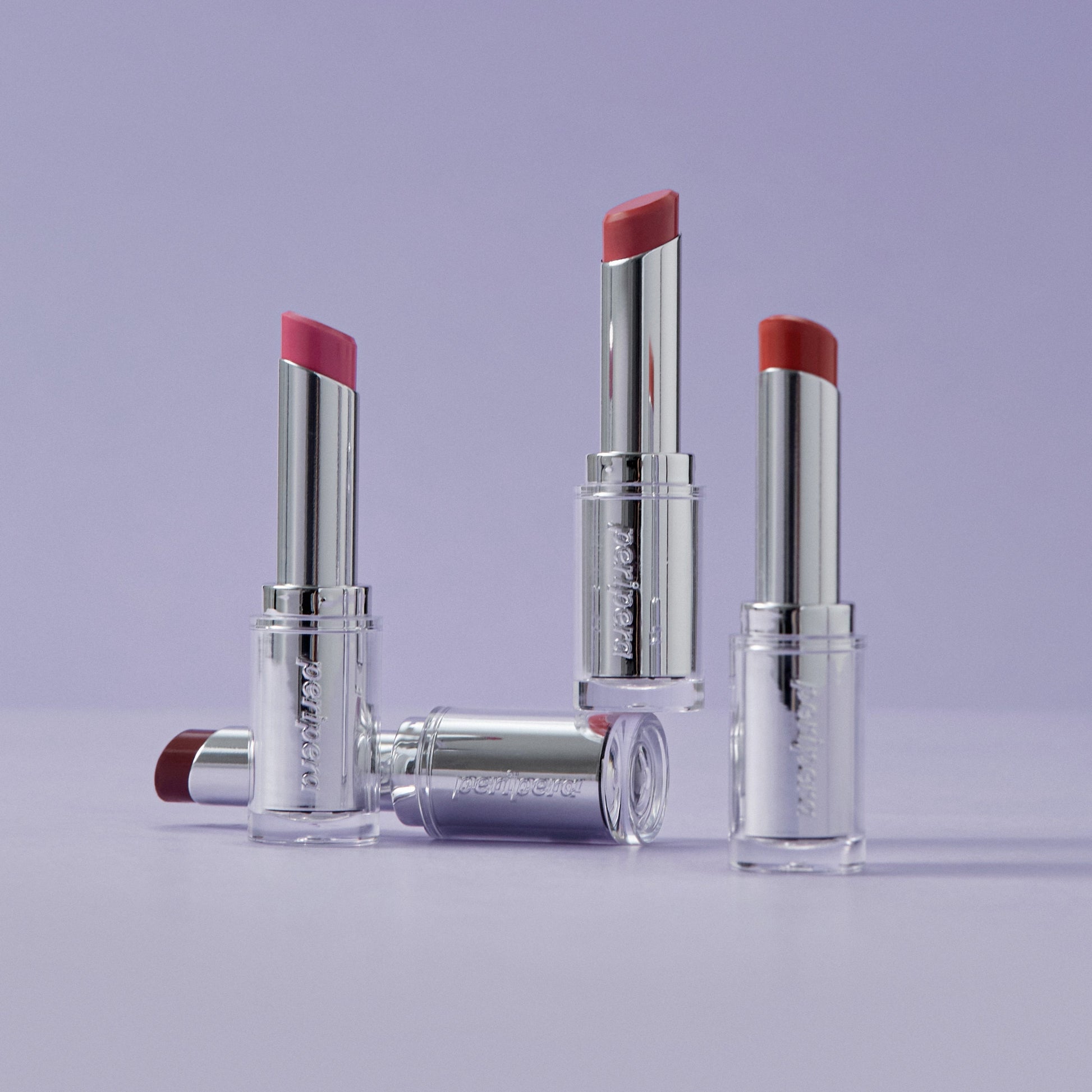 Peripera Ink Mood Glowy Balm lipstick in a vibrant shade, shown in a close-up of the smooth, glossy lip application.