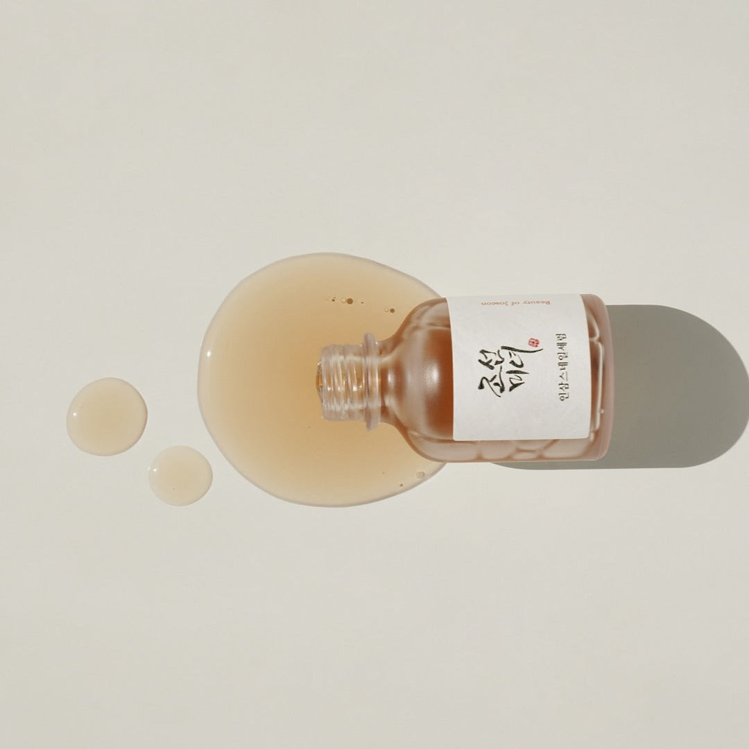 Beauty of Joseon Revive Serum with ginseng and snail mucin in a 30ml bottle, shown in a clear glass container with a dropper.