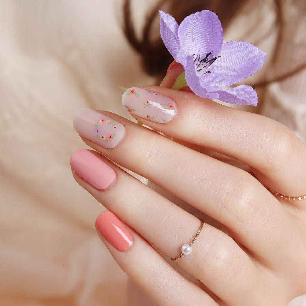 Glossy Blossom floral blusher gel nail strips with pink and white floral pattern on neatly manicured nails.