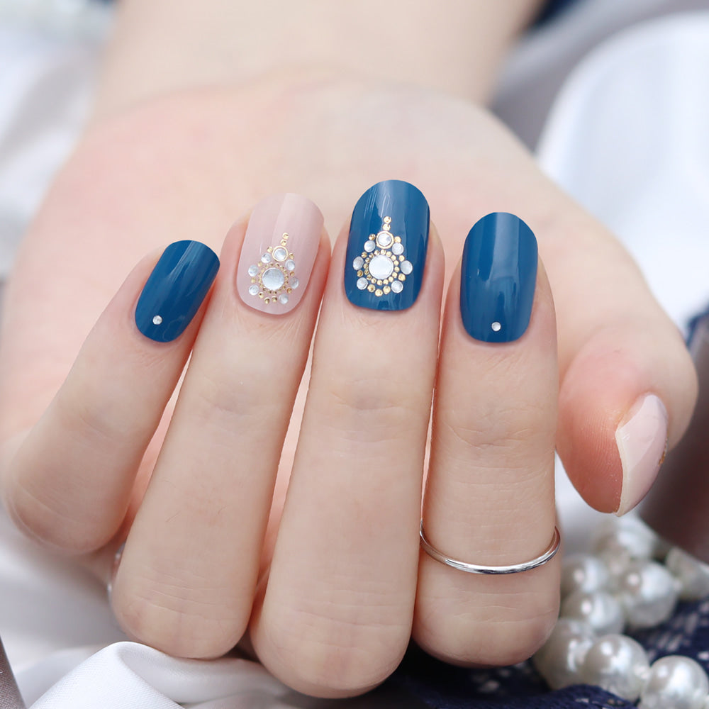 Glossy Blossom Blue Eye gel nail strips with vibrant blue eye pattern on sleek nail art design.