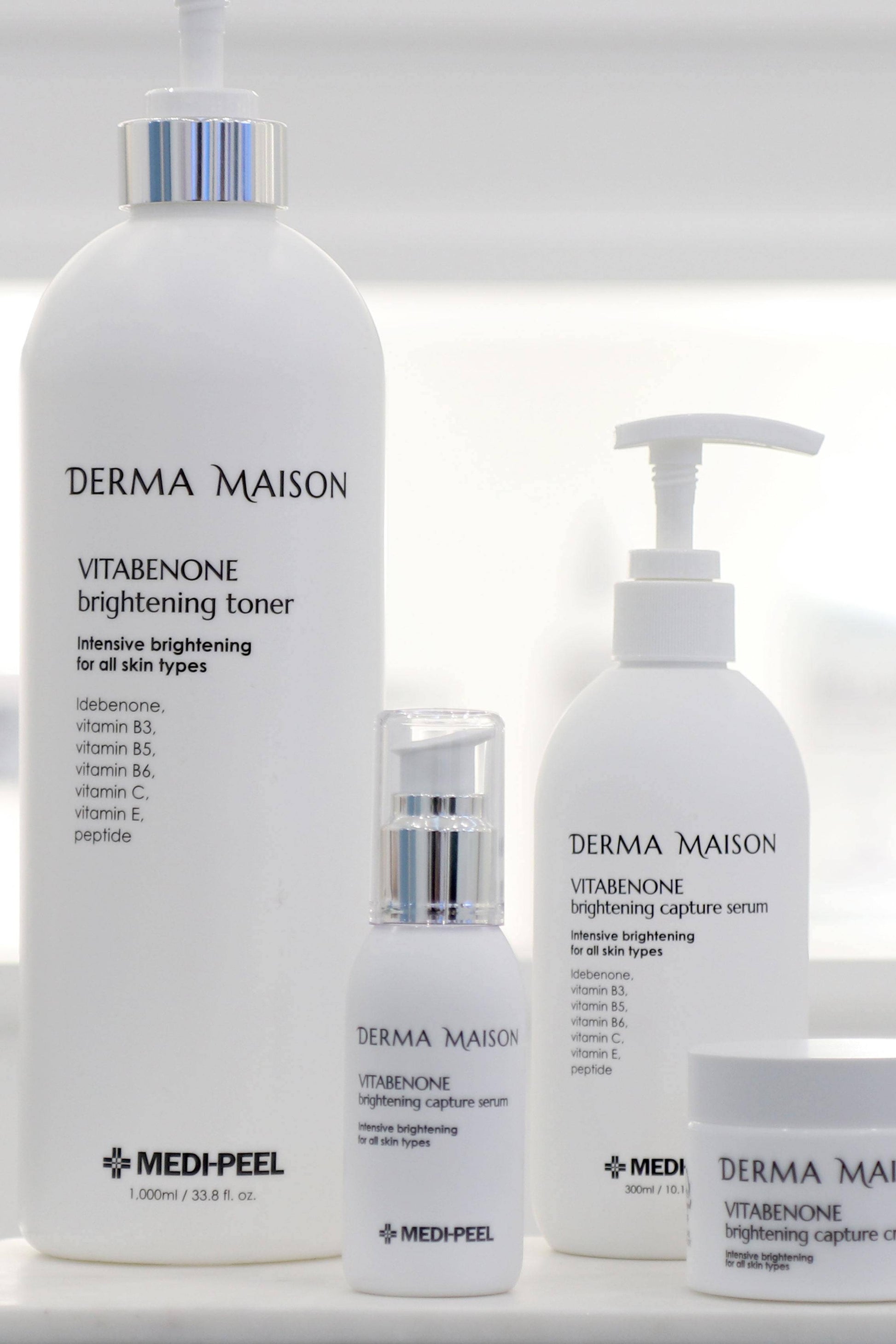 Derma Maison Vitabenone Brightening Capture Serum in a clear glass bottle, showcasing the serum's smooth, lightweight texture.