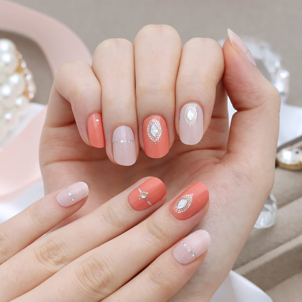 Glossy Blossom Christon gel nail strips applied on nails with floral and geometric patterns, showcasing vibrant, glossy nail art.