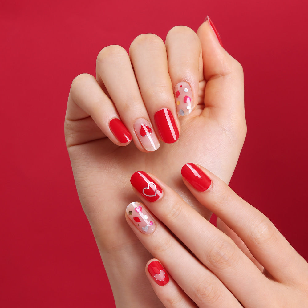 Glossy Blossom Gel Nail Strips in Hot Romance design, showcasing vibrant, glossy red and pink floral nail art on natural nails.