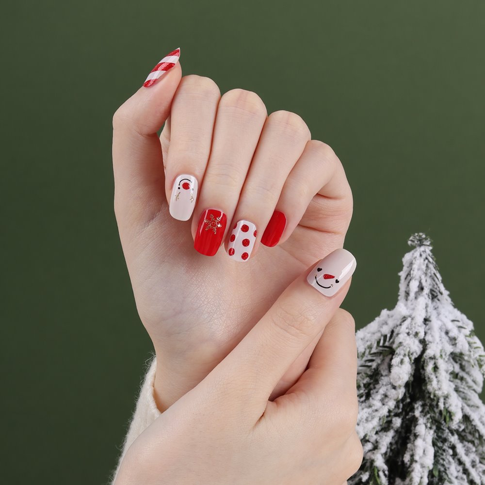 Glossy Blossom Merry Holiday gel nail strips featuring festive red, green, and gold holiday-themed nail designs on manicured nails.