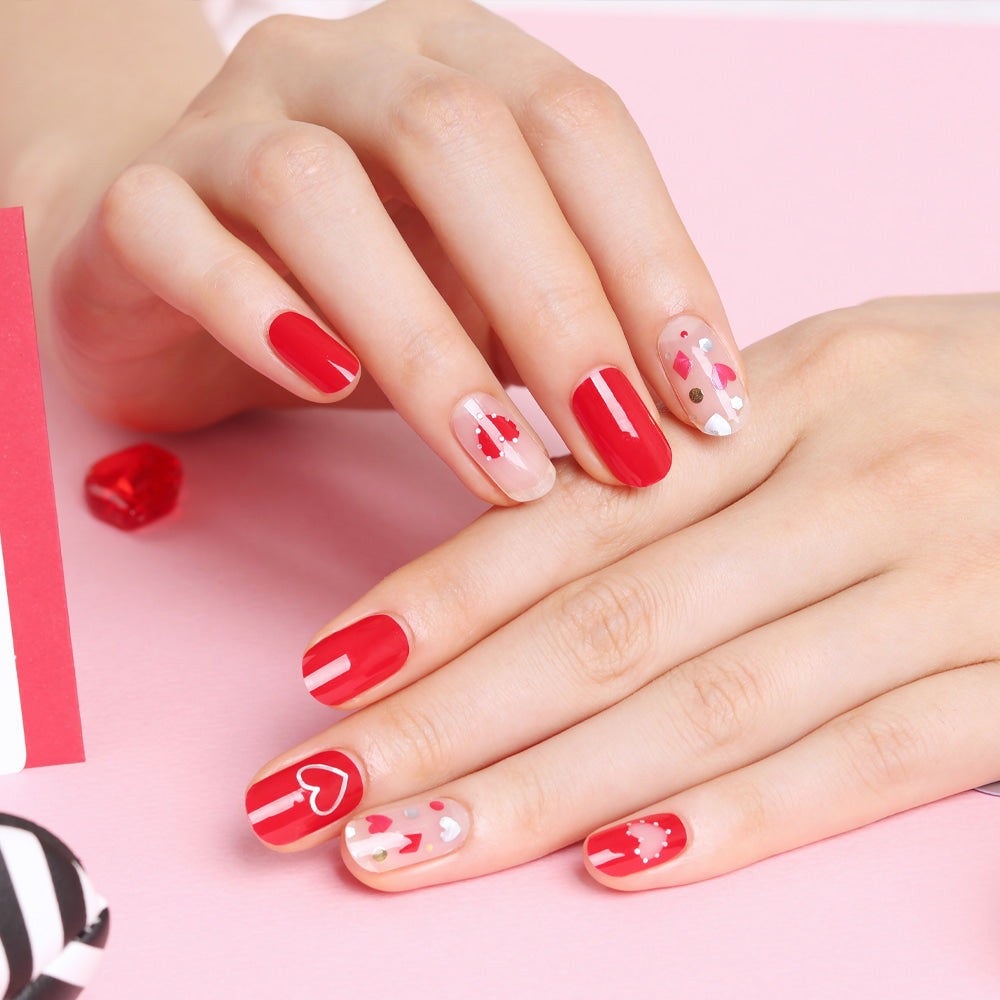 Glossy Blossom Hot Romance gel nail strips on neatly manicured nails with a vibrant, romantic red and pink floral design.