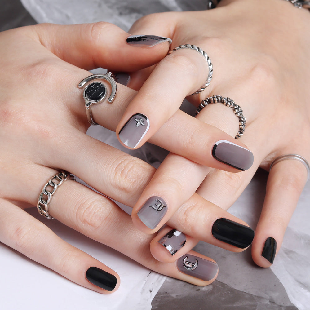 Glossy Blossom Hip Black gel nail strips on nails with a sleek, shiny black design for a stylish manicure.